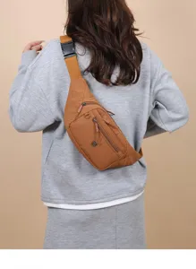 Back view of a casual brown nylon chest bag worn by a model in a grey sweatshirt