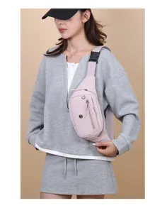 Female model wearing a stylish light pink nylon crossbody chest bag for casual sports
