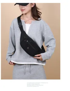Fashionable black lightweight chest bag worn by model for casual outdoor activities