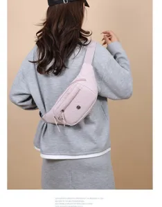 Detailed view of the lightweight pink nylon crossbody waist bag worn by model on back