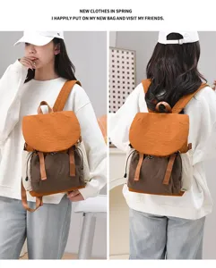 Lifestyle view showing front and back of women's casual large capacity color-block backpack