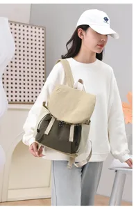 Model wearing large capacity casual travel backpack for women in green and beige
