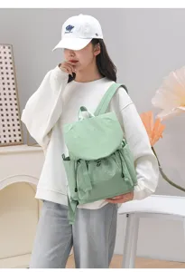 Detailed lifestyle view of a lightweight mint green casual travel backpack for women