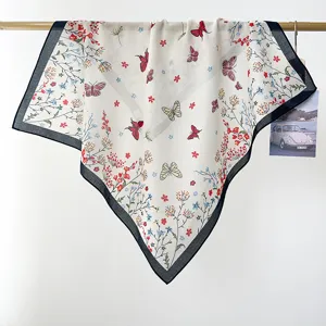 Detail of pastoral style cotton square scarf with butterfly and floral print.