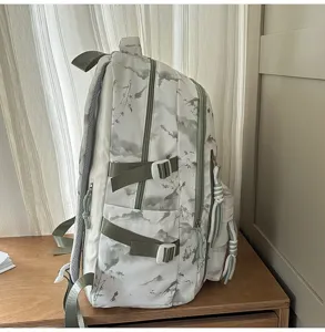 Side view of white school backpack with elegant grey and green landscape pattern details