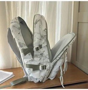 Detail view showing large capacity and multi-compartment interior for landscape print school backpack