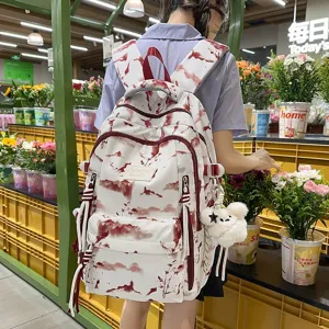 Detailed back view of a stylish white backpack with red landscape print worn by a student in a shop