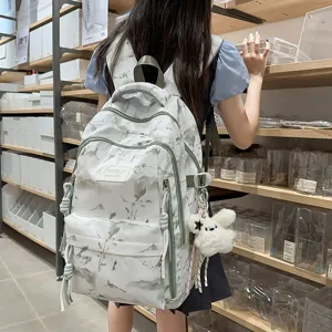 Minimalist student backpack with mountain landscape pattern and cute plush bunny charm
