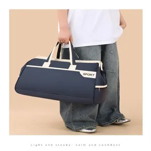 Large capacity navy blue travel duffel bag held by person for sports gym or business trip