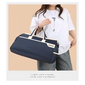 Large navy blue travel duffel bag for sports and fitness displayed by an Asian model