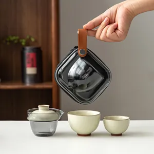 Portable ceramic travel tea set including one teapot and two cups with a black carrying case