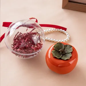 Elegant persimmon-shaped ceramic candy box and clear favor ball for wedding gifts