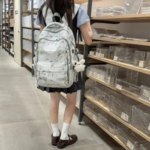 Student backpack with mountain landscape print in a minimalist lifestyle store