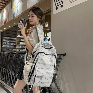 Stylish Korean white backpack featuring grey landscape print carried by an Asian model