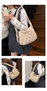 Quilted cloud shoulder bag detail, soft beige hobo handbag with comfortable wide strap.