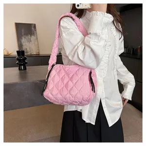 Pink quilted shoulder bag for women, trendy puffer tote with pleated design and spacious interior.