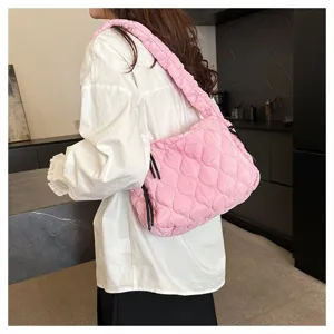 Detailed view of the stylish pink quilted cloud bag showcasing soft puffer texture and strap.