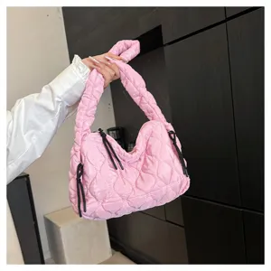 Detailed view of the pink quilted cloud bag, featuring soft pleated texture and stylish straps.