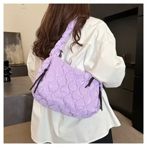 Detail view of a light purple quilted cloud shoulder bag with stylish braided strap and cords.