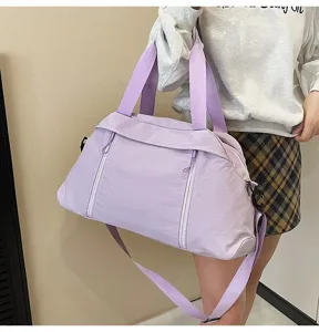 Lavender purple sports gym bag for yoga and travel, shown being carried by a model outdoors.