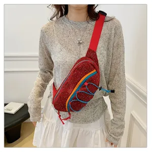 Close-up of red corduroy sports chest bag with vibrant blue and orange accent cords.