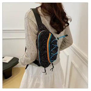 Side view detail of a trendy black sporty chest bag with colorful stripe accents.