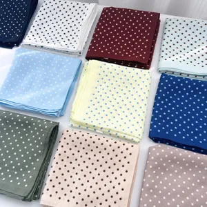 Colorful polka dot square scarves arranged in a neat grid for a sweet Korean style look
