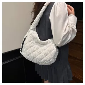 Detail view of the white quilted cloud shoulder bag with pleated design and comfortable strap.