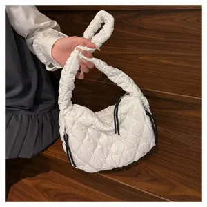 White quilted cloud shoulder bag with chic pleated strap and casual drawstring design.