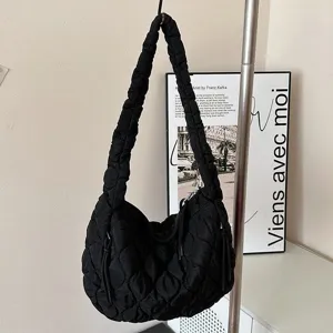 Black quilted cloud shoulder bag, minimalist pleated hobo tote for women daily commuter fashion.