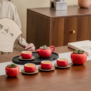 Elegant red persimmon ceramic tea set with teapot four cups tray and canisters
