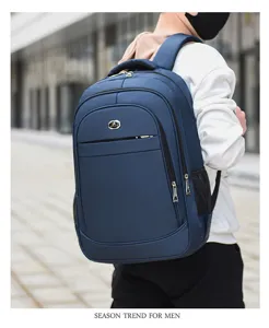 Man wearing a navy blue large capacity business laptop backpack outdoors
