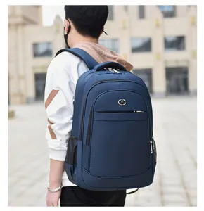 Man wearing a large navy blue backpack, showing side profile and comfortable shoulder straps.
