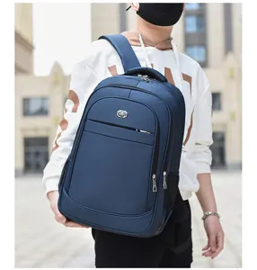Close-up of a man carrying a navy blue large capacity business laptop backpack outdoors.