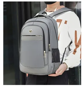 Large capacity grey laptop backpack worn by a person in a casual lifestyle setting