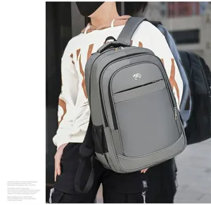 Close-up of a grey large capacity laptop backpack worn by a male model outdoors