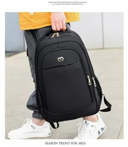 Man carrying a large capacity black casual backpack for business and travel use