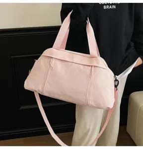 Detailed view of pink versatile sports gym bag featuring adjustable shoulder strap