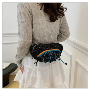 Women's sporty polka dot waist bag shown from a back perspective on a model.