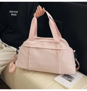 Detailed view of a stylish pink sports gym bag with handles and crossbody strap