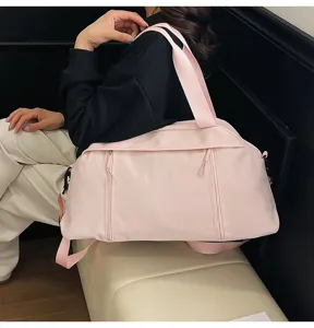 Side view of a pink lightweight sports gym bag featuring shoulder straps and zippers