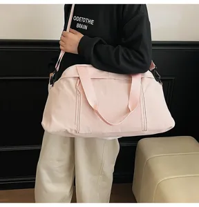 Large light pink sports gym bag for yoga or travel carried by a model in a casual outfit