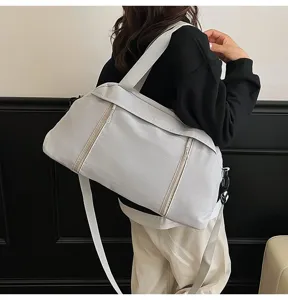 Detail of a grey minimalist gym bag carried over the shoulder for fitness or travel