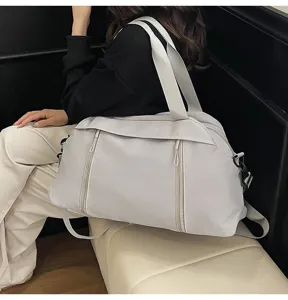 Large light grey travel gym bag shown in a professional lifestyle indoor setting view