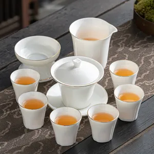 Elegant white porcelain Gongfu tea set with gold rim featuring Gaiwan and cups