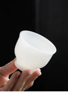 Close-up of a translucent suet jade porcelain teacup with elegant white finish