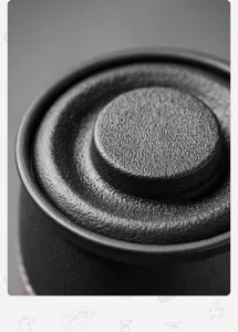 Macro shot of the matte black ceramic texture on a premium tea mug lid detail view