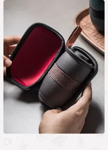 Close-up of matte ceramic tea cup with woven band and portable red-lined zipper case