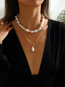 Close-up view of elegant double layered baroque pearl necklace on a female model's neck