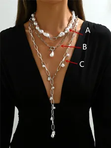 Detailed view of three-layer necklace set with baroque pearls and Y-shaped tassel